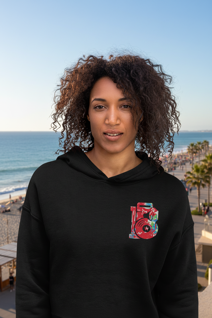 Hip Hop Crop Hoodie - close-up front view with colorful embroidered logo, daytime seaside background